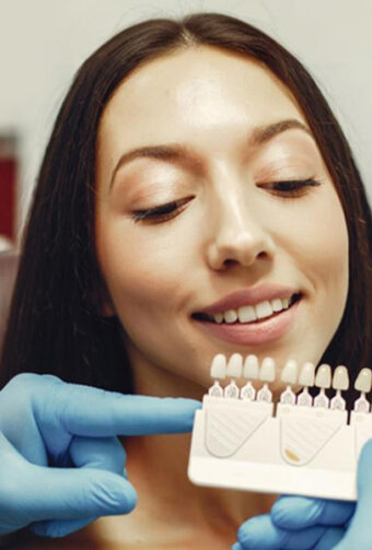 Smiling girl trying dental veneers.